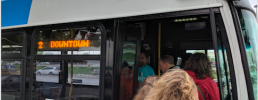 people boarding a bus going downtown