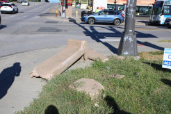 A sidewalk near 40th and Dodge blocked by a broken bench